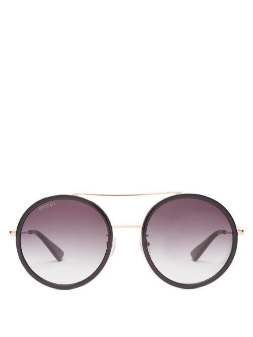 Gucci - Cut to an oversized round silhouette, Gucci's black sunglasses echo the house's retro sensib