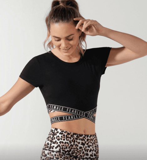 彈性交叉縷空下擺印有Fearless Female字樣.吸濕排汗，快乾不濕冷短版設計