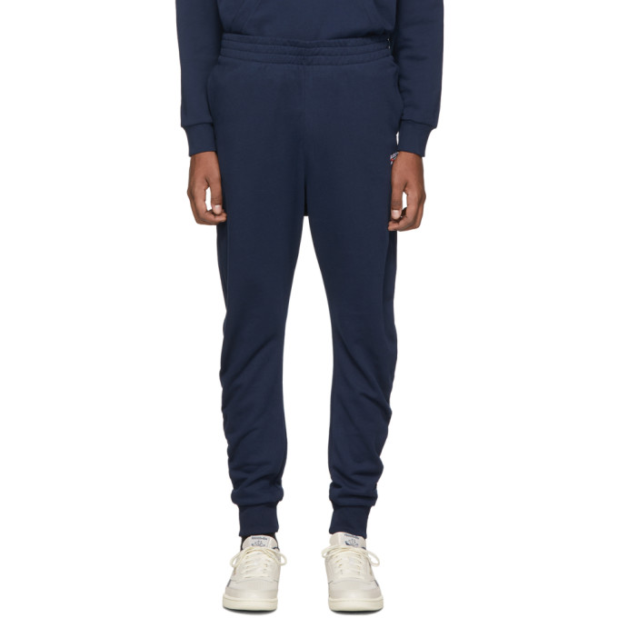 Tapered French terry lounge pants in navy. Mid-rise. Three-pocket styling. Concealed drawstring at e