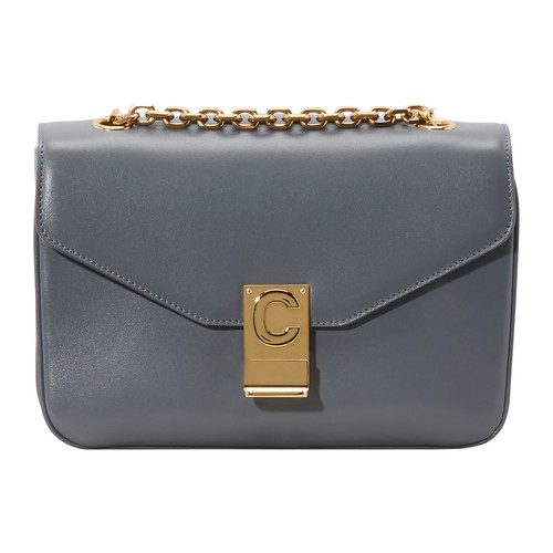 This Medium C bag in calfskin is by Celine. This piece's sliding chain enables you to wear it on the