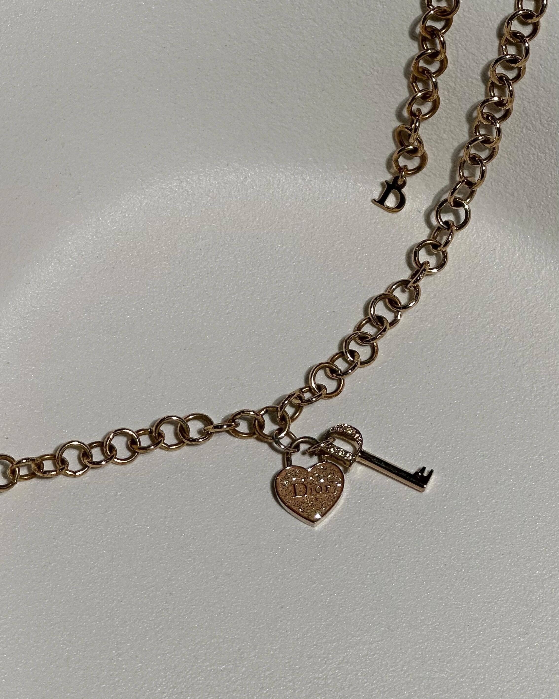 Gold dior lock outlet necklace